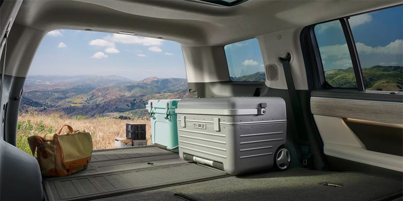 Spacious Hyundai Santa Fe cargo area with outdoor gear and mountain view