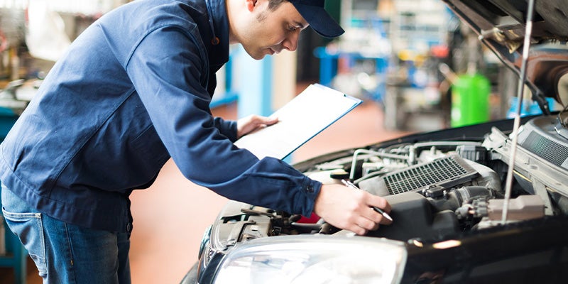 Bentley Hyundai in Huntsville AL technician looking at engine and holding a clipboard