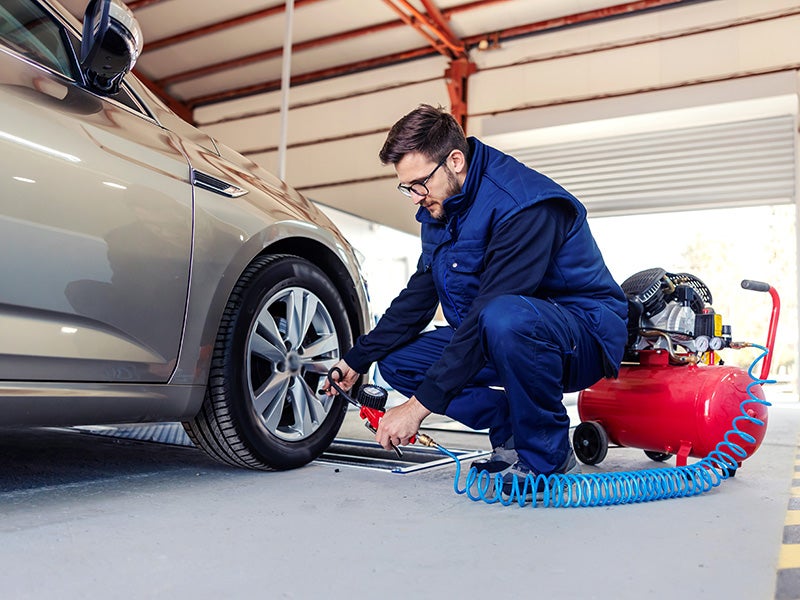 Bentley Hyundai in Huntsville AL technician changing a tire on a car