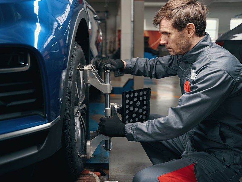 Bentley Hyundai in Huntsville AL technician changing a tire